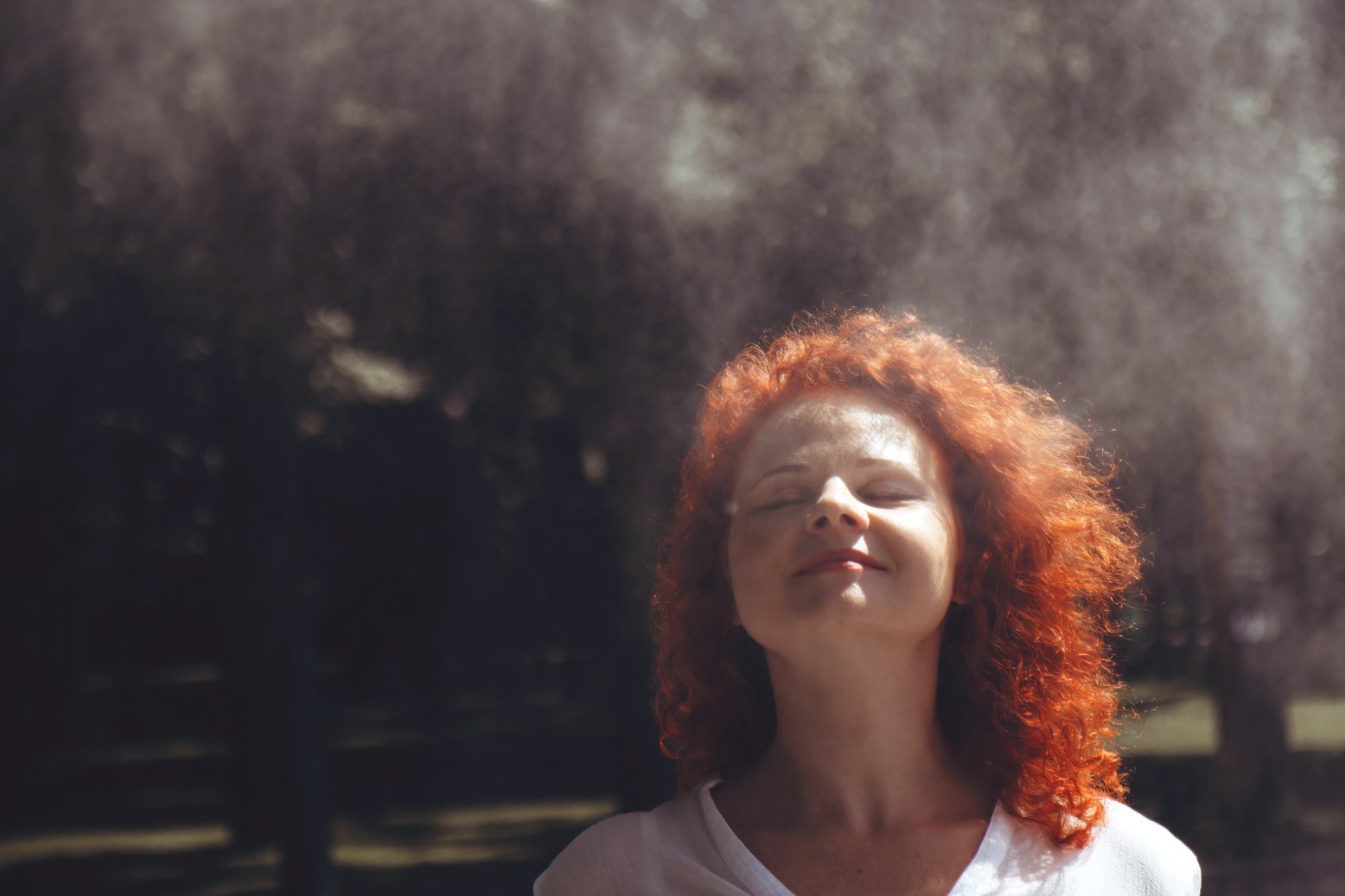 Woman with Red Curly Hair Under Drizzle 